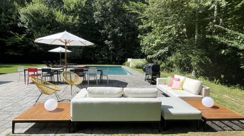 An outdoor space with pool furniture